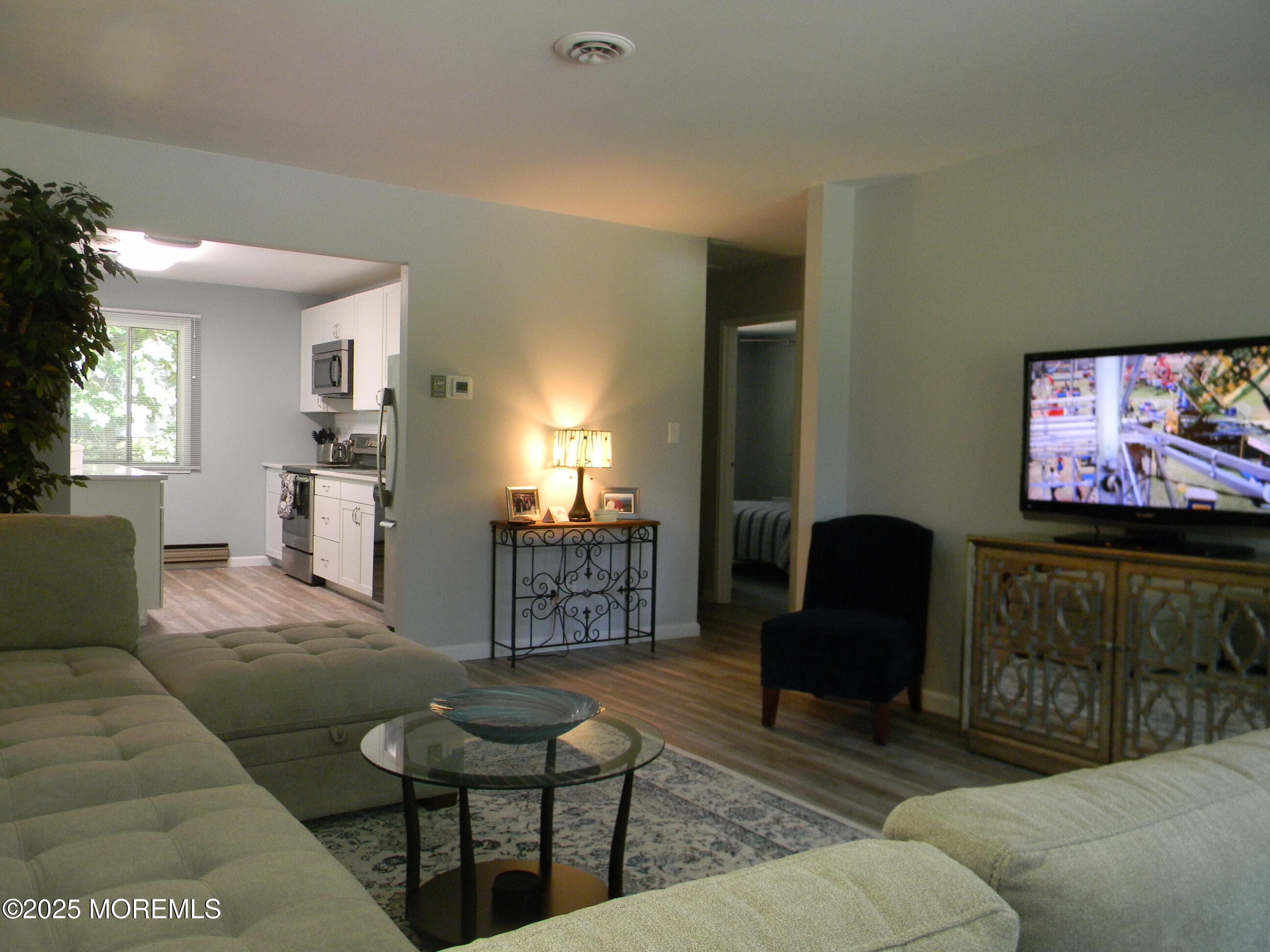 7 B Roosevelt City Road, Unit B Whiting, NJ 08759 - Photo 21 of 48 a living room with furniture and a flat screen tv