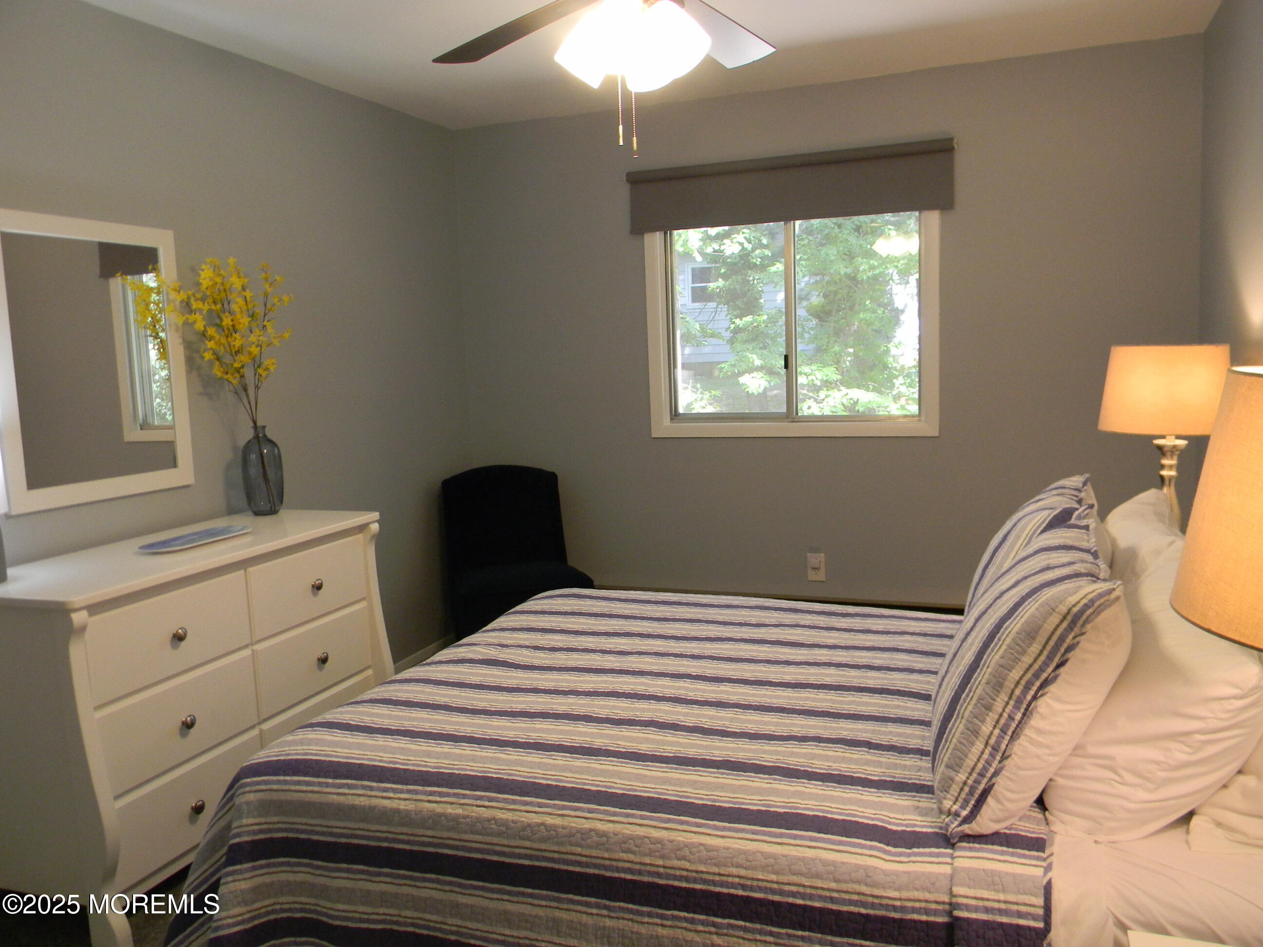 7 B Roosevelt City Road, Unit B Whiting, NJ 08759 - Photo 26 of 48 a bedroom with a bed and a chandelier
