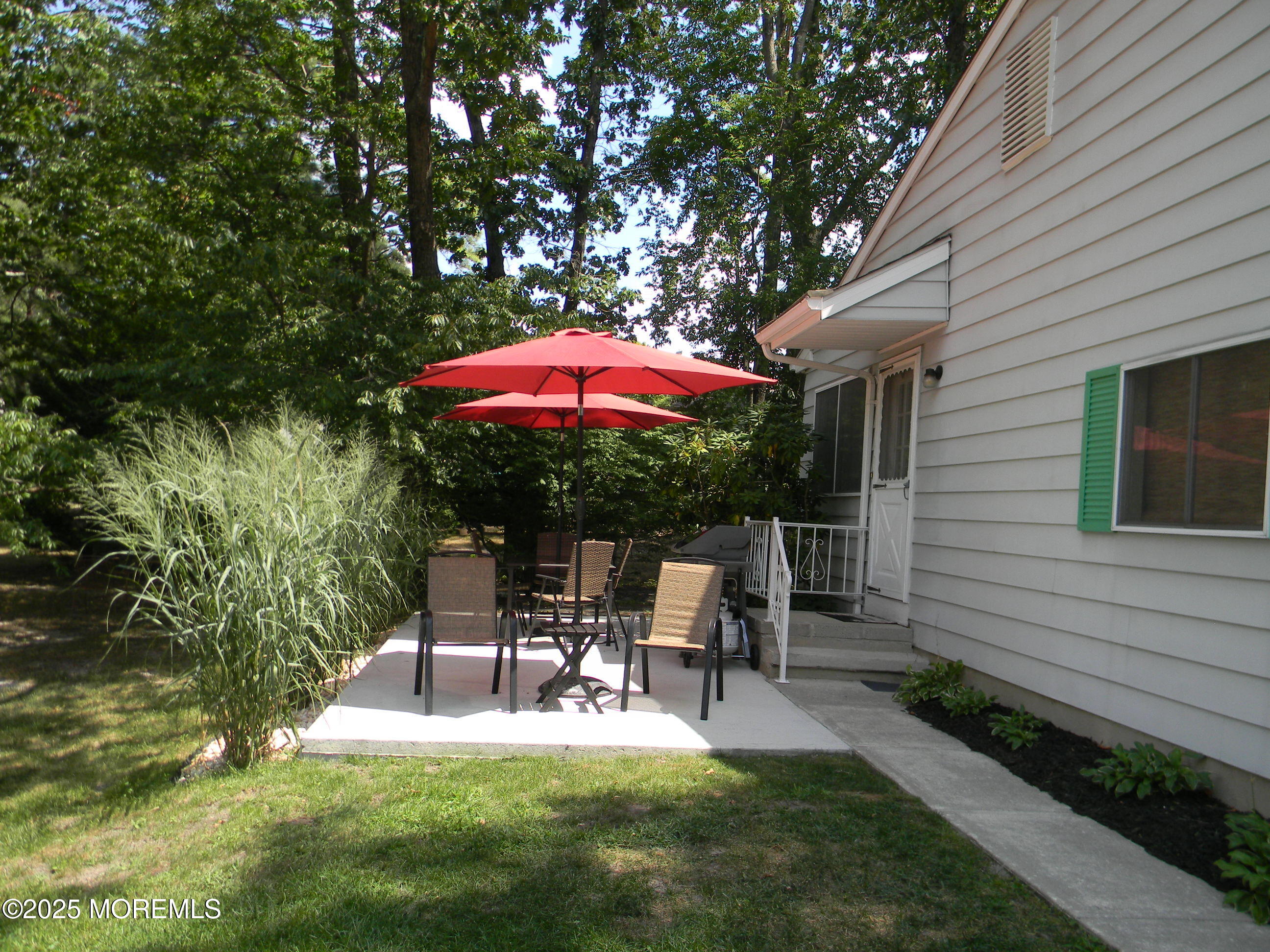 7 B Roosevelt City Road, Unit B Whiting, NJ 08759 - Photo 29 of 48 a view of a house with backyard sitting area and garden
