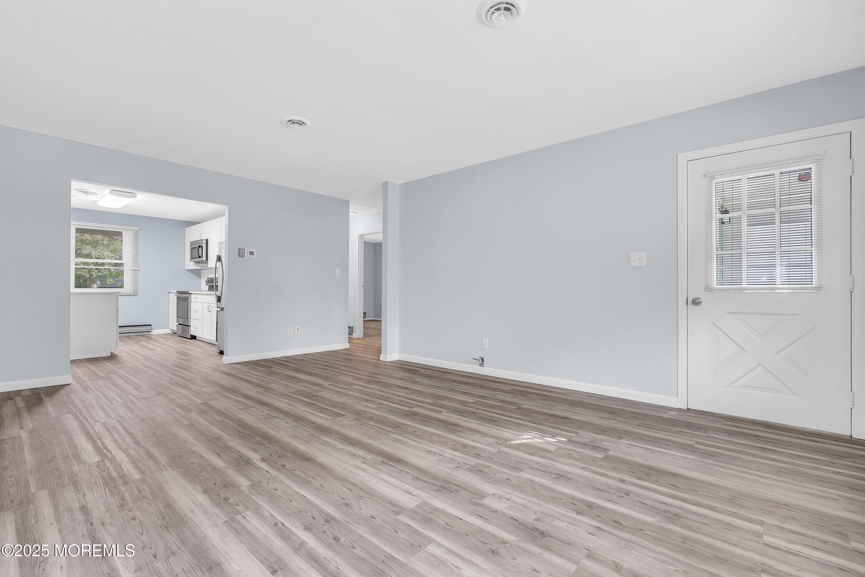 7 B Roosevelt City Road, Unit B Whiting, NJ 08759 - Photo 36 of 48 a view of empty room with wooden floor and fan