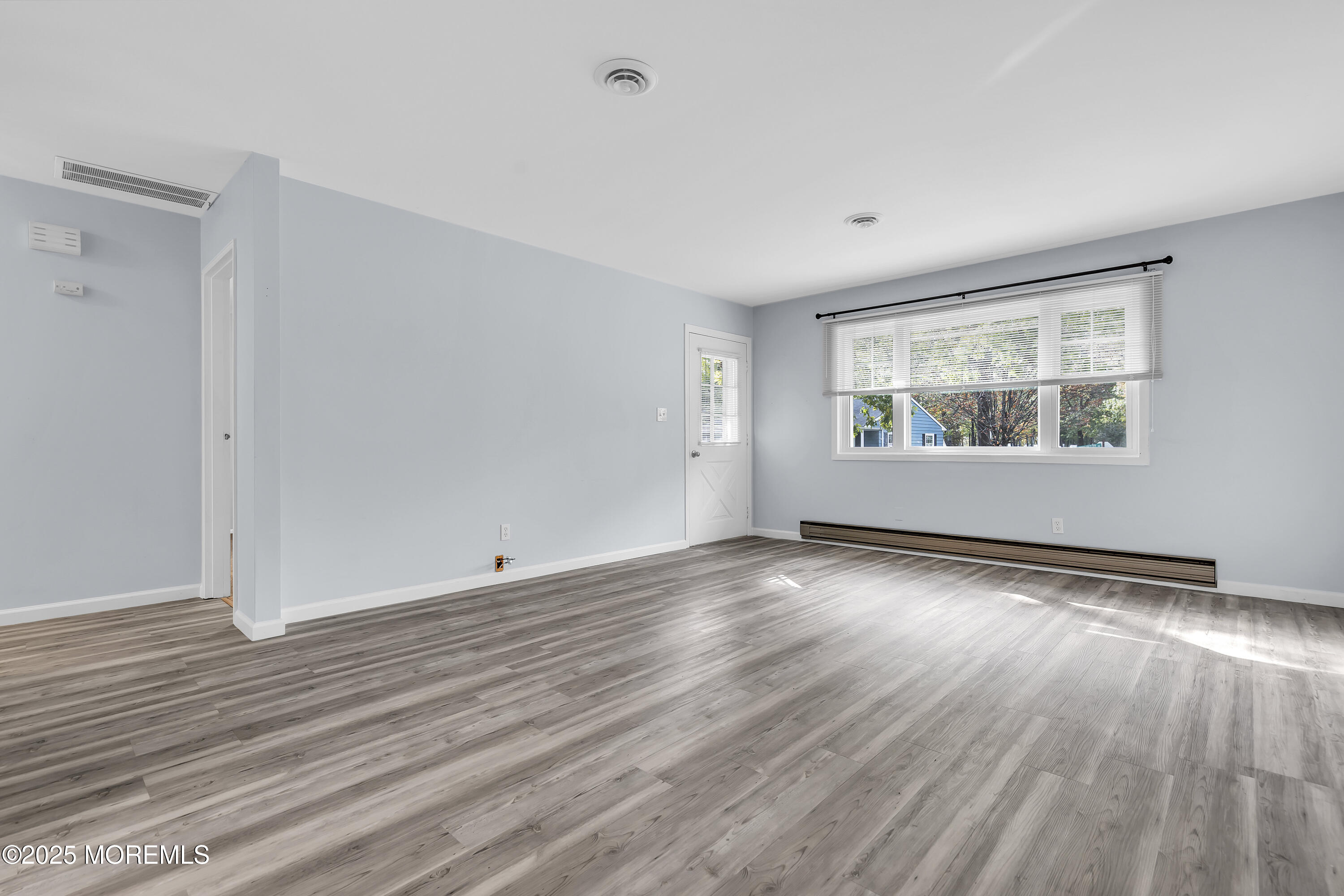 7 B Roosevelt City Road, Unit B Whiting, NJ 08759 - Photo 37 of 48 an empty room with wooden floor and windows