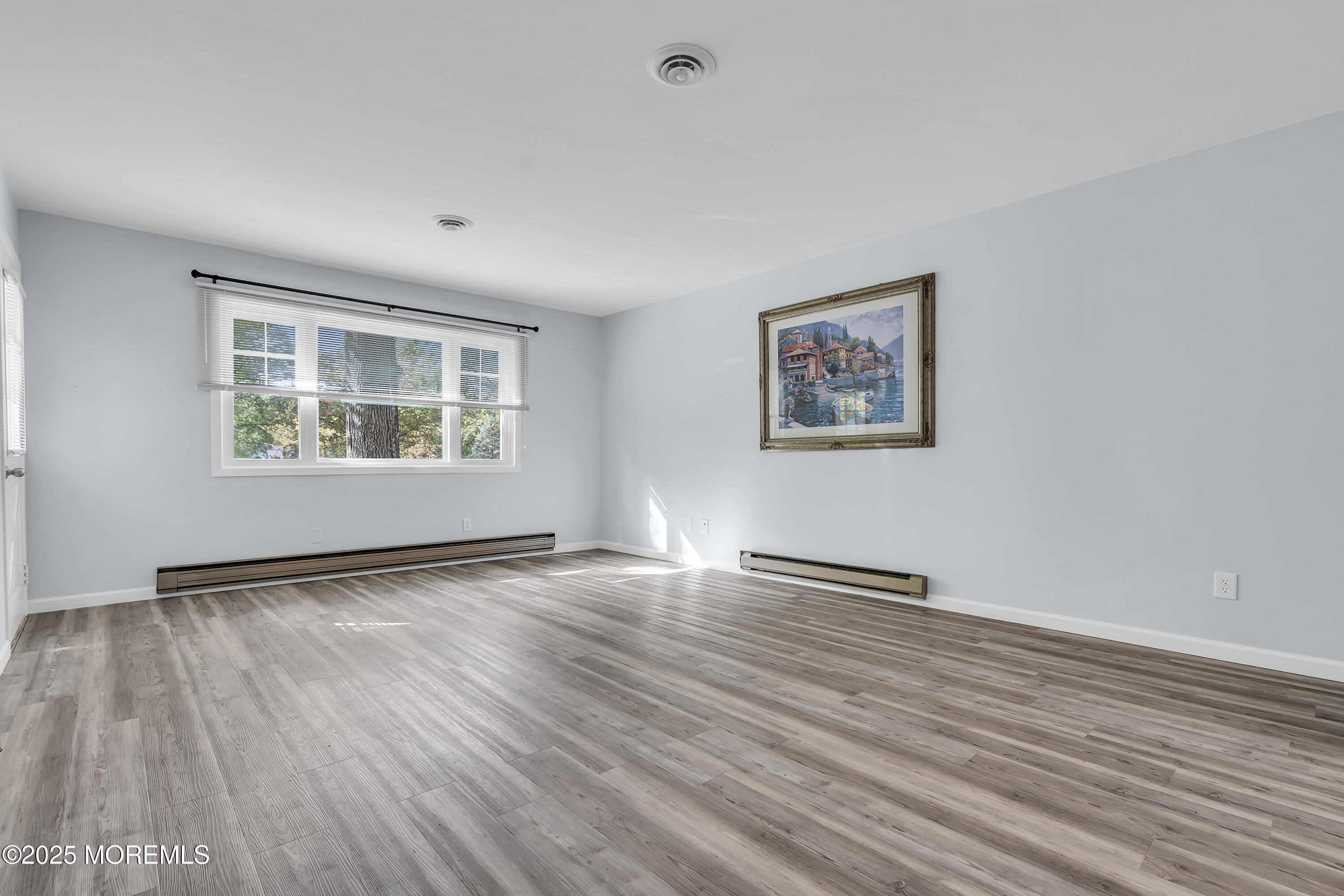 7 B Roosevelt City Road, Unit B Whiting, NJ 08759 - Photo 38 of 48 a view of an empty room with wooden floor and a window