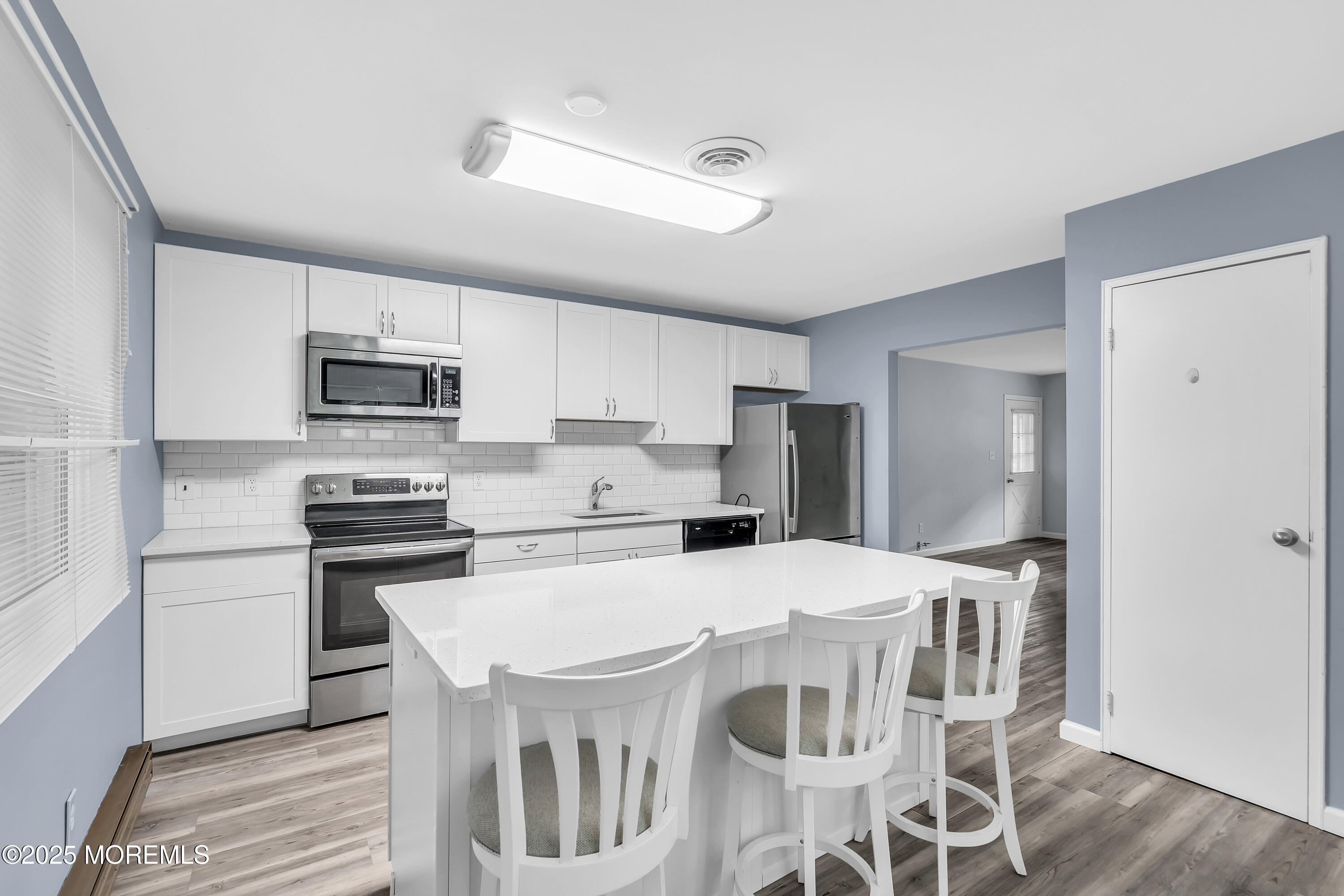 7 B Roosevelt City Road, Unit B Whiting, NJ 08759 - Photo 41 of 48 a kitchen with stainless steel appliances a stove a sink refrigerator and microwave