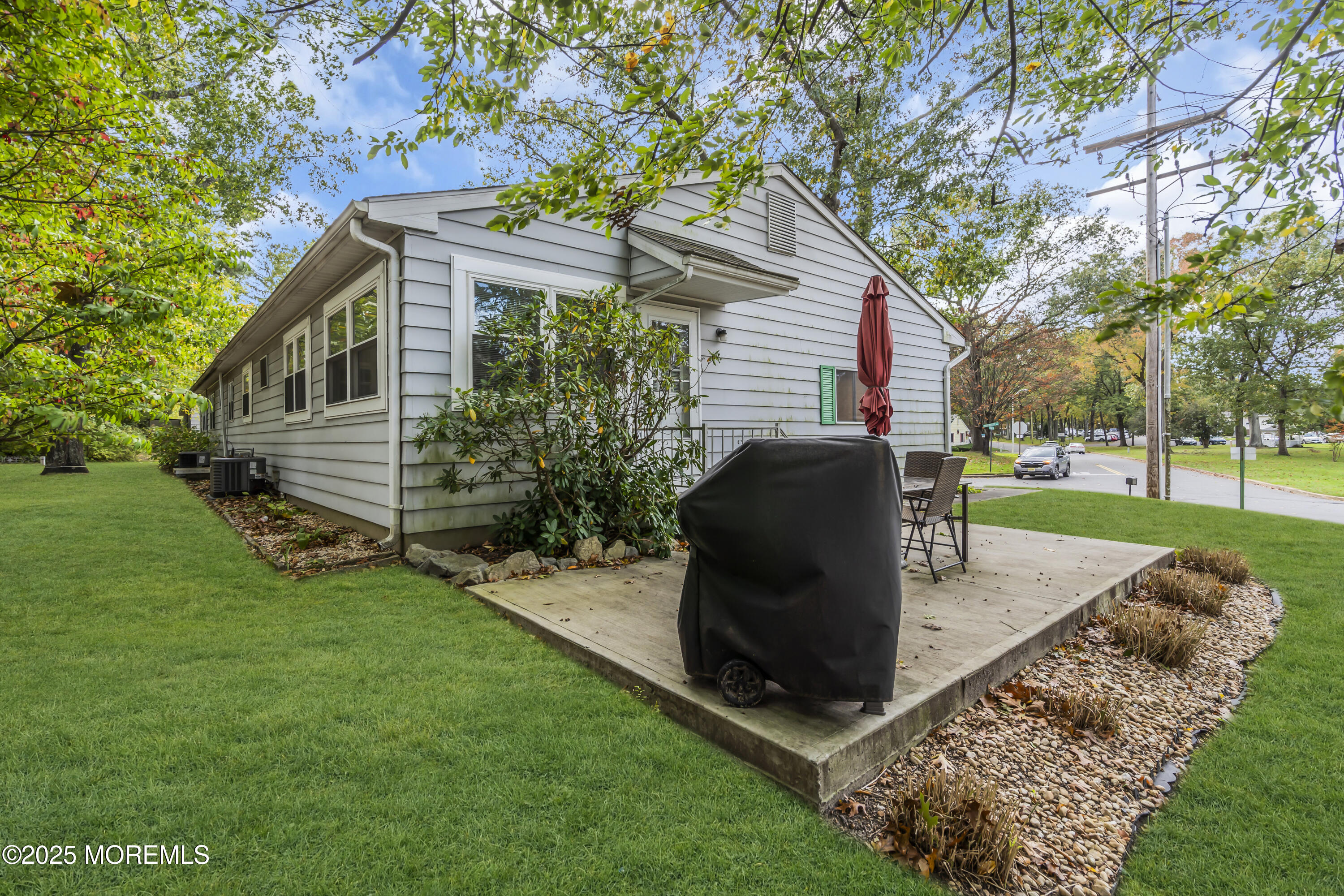 7 B Roosevelt City Road, Unit B Whiting, NJ 08759 - Photo 46 of 48 a view of a backyard with table and chairs potted plants and large tree