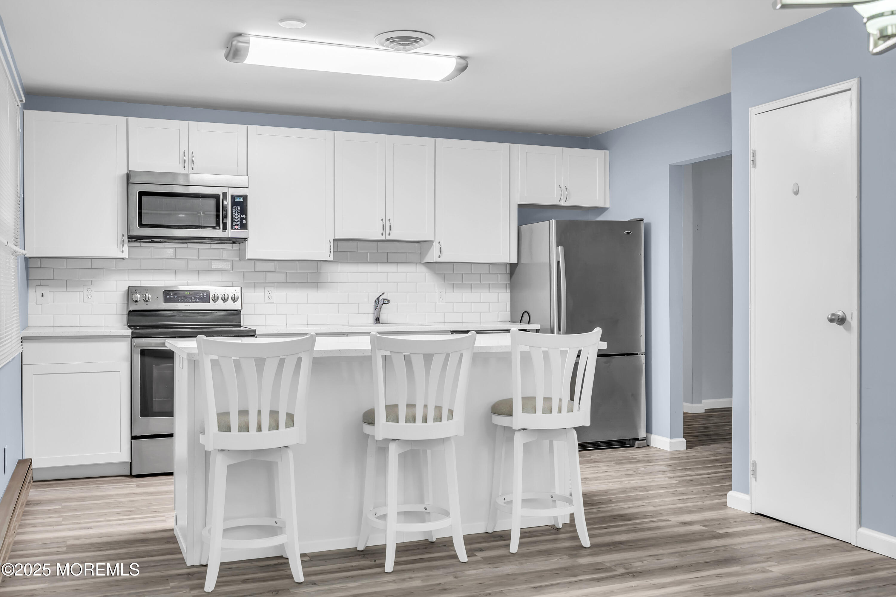7 B Roosevelt City Road, Unit B Whiting, NJ 08759 - Photo 5 of 48 a kitchen with stainless steel appliances kitchen island granite countertop a refrigerator and microwave