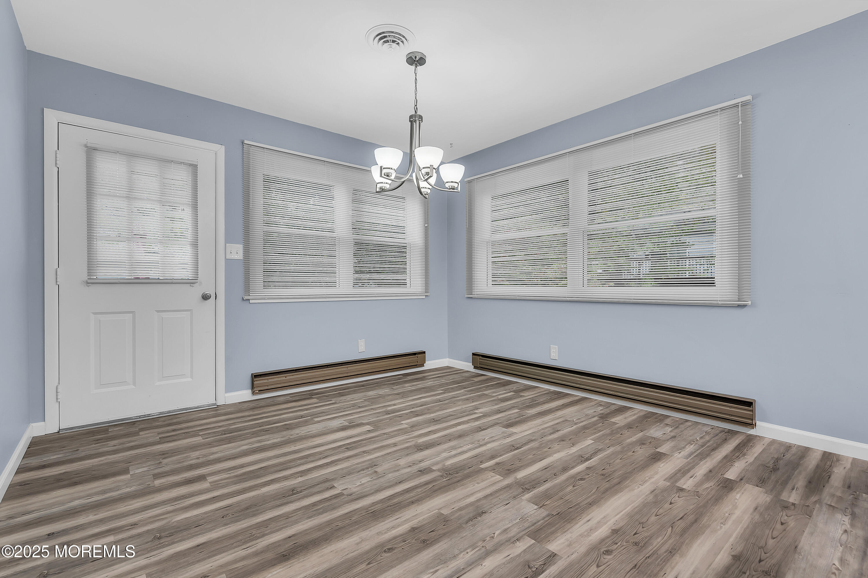 7 B Roosevelt City Road, Unit B Whiting, NJ 08759 - Photo 7 of 48 a view of an empty room with wooden floor and a window