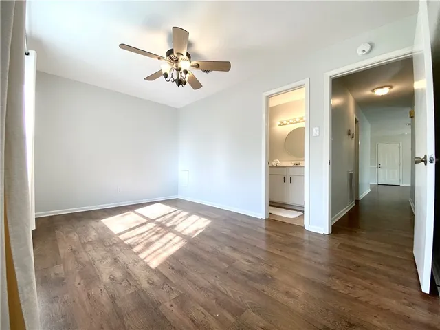 a view of an empty room and wooden floor