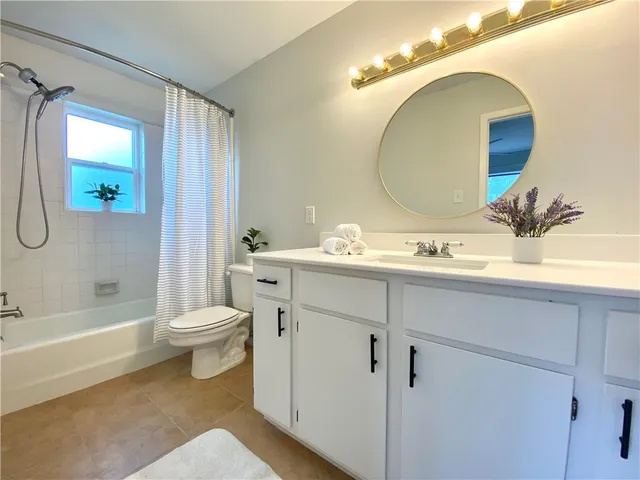 a bathroom with a double vanity sink mirror and toilet