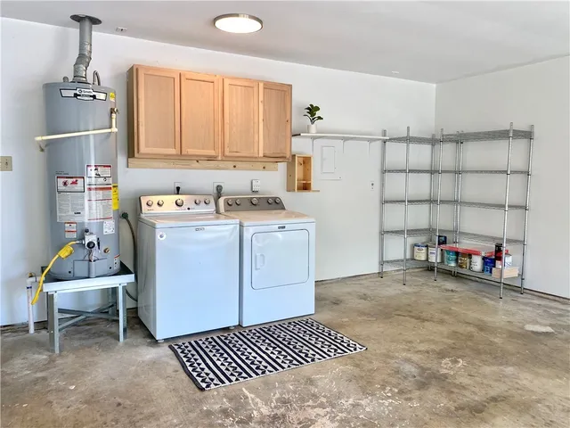 a utility room with cabinets dryer and washer