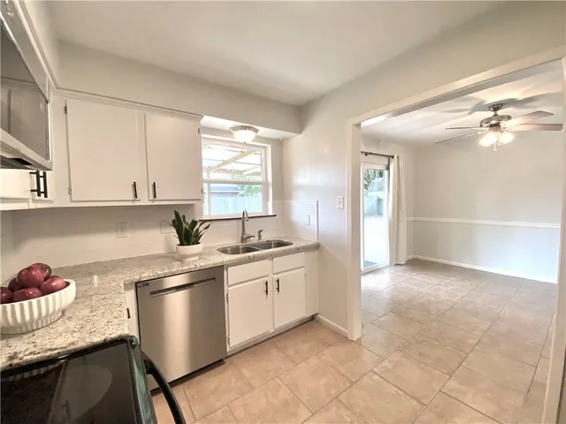 a kitchen with a sink cabinets and window