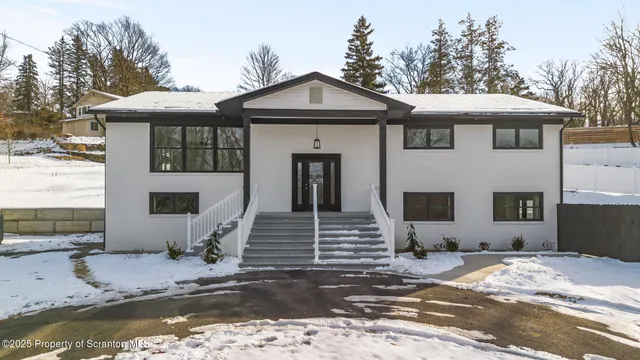 a view of a house with snow on the road