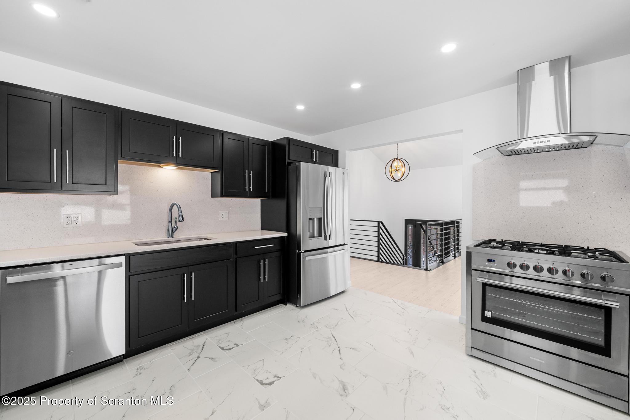 80 Elmhurst Boulevard Scranton, PA 18505 - Photo 14 of 56 a kitchen with stainless steel appliances a stove a sink and a refrigerator