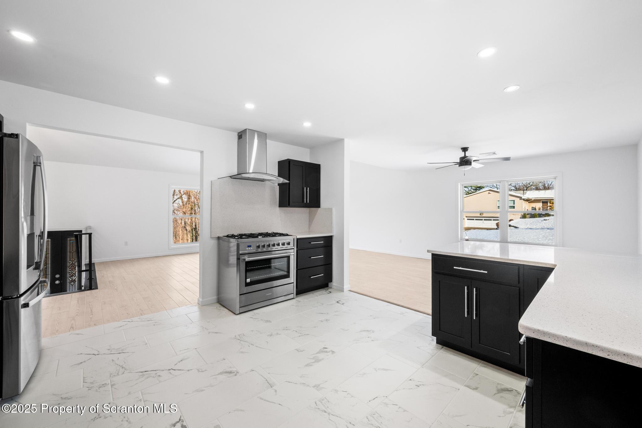80 Elmhurst Boulevard Scranton, PA 18505 - Photo 15 of 56 a kitchen with stainless steel appliances a refrigerator and a stove top oven