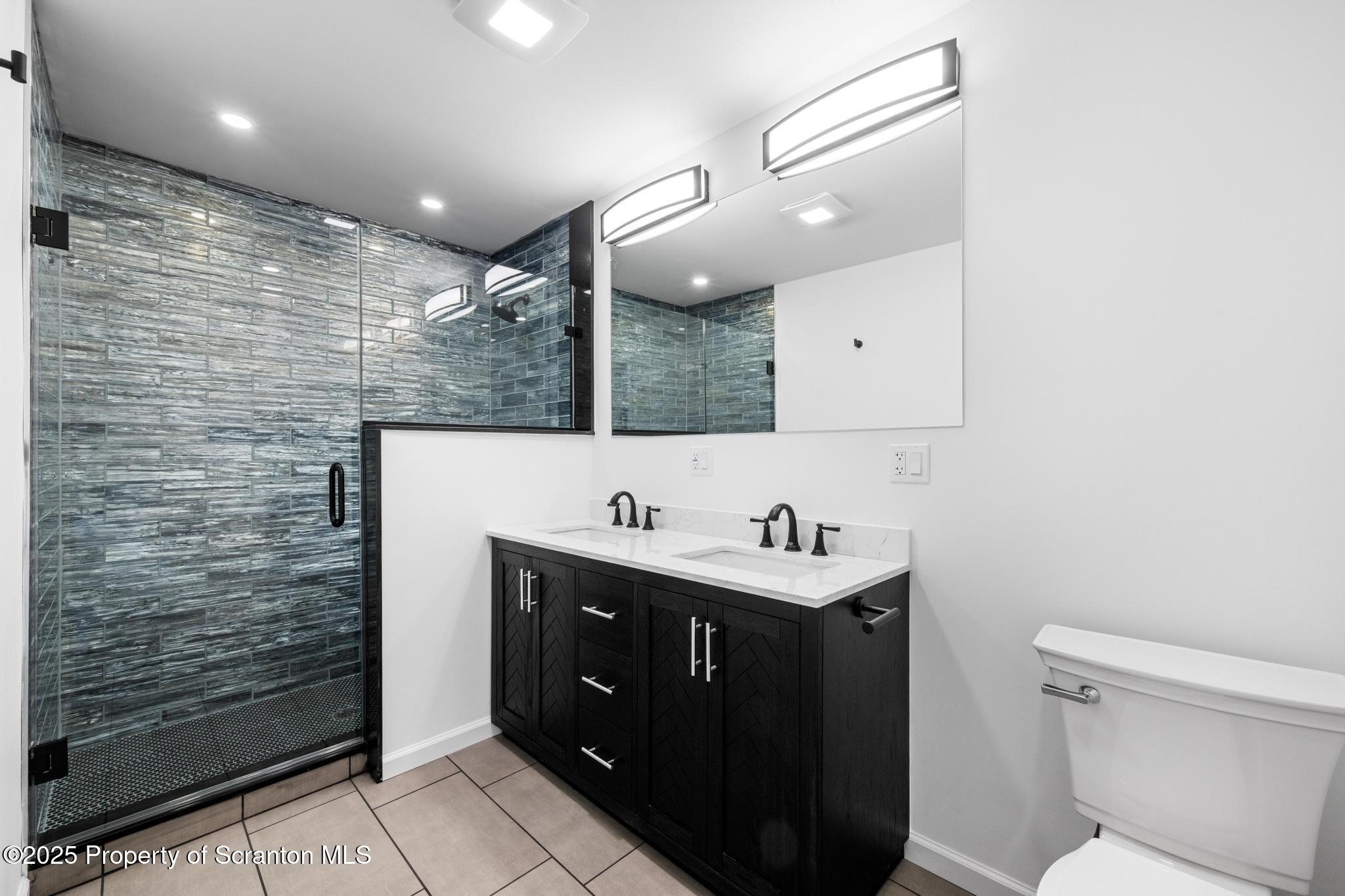 80 Elmhurst Boulevard Scranton, PA 18505 - Photo 18 of 56 a bathroom with a sink a toilet and mirror