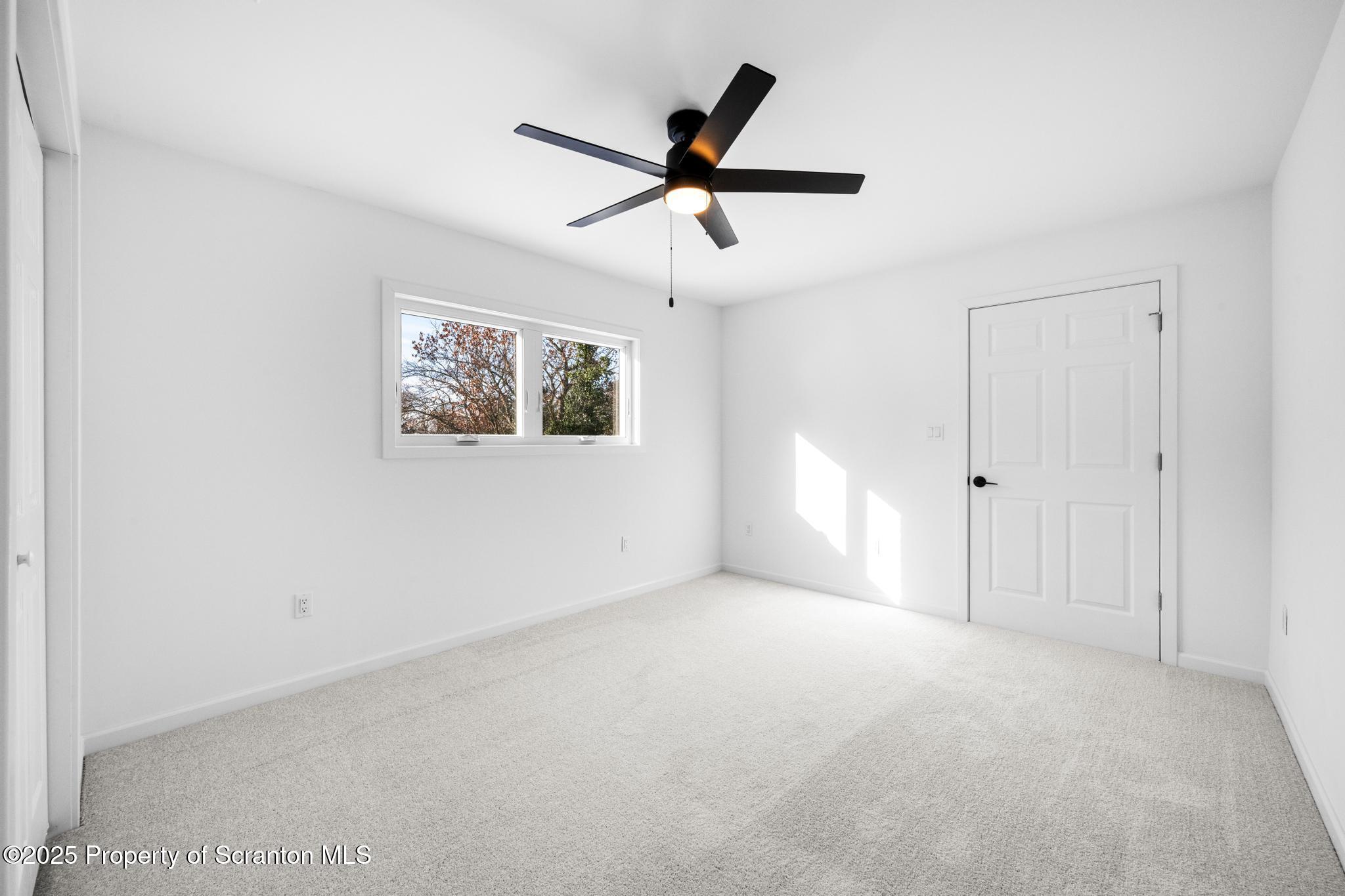 80 Elmhurst Boulevard Scranton, PA 18505 - Photo 21 of 56 a view of a livingroom with a ceiling fan & window