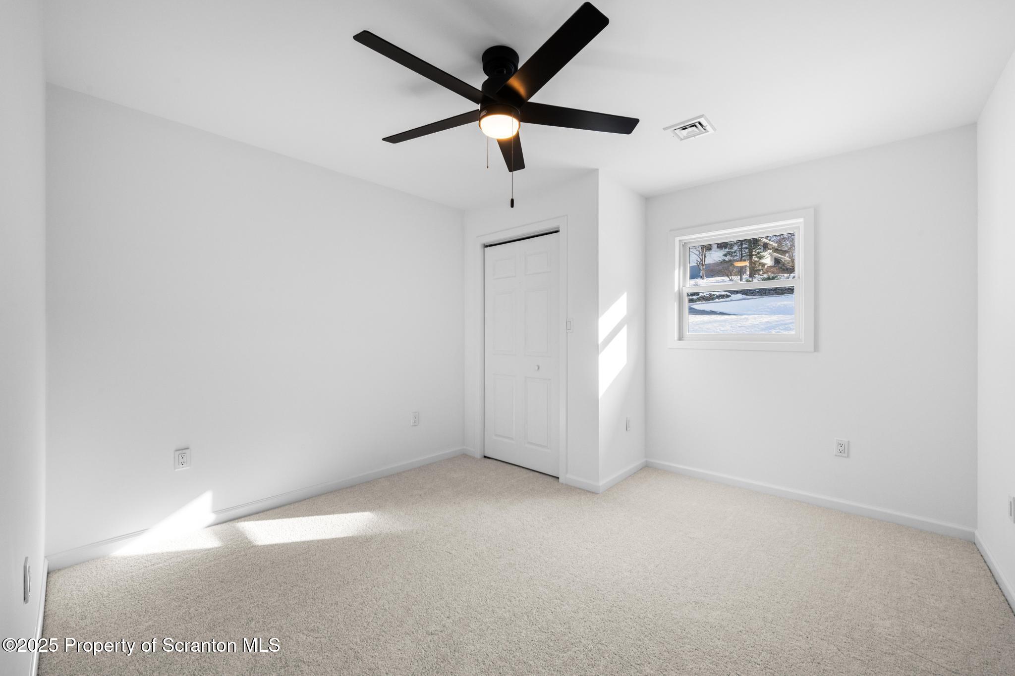 80 Elmhurst Boulevard Scranton, PA 18505 - Photo 24 of 56 an empty room with a window and a fan