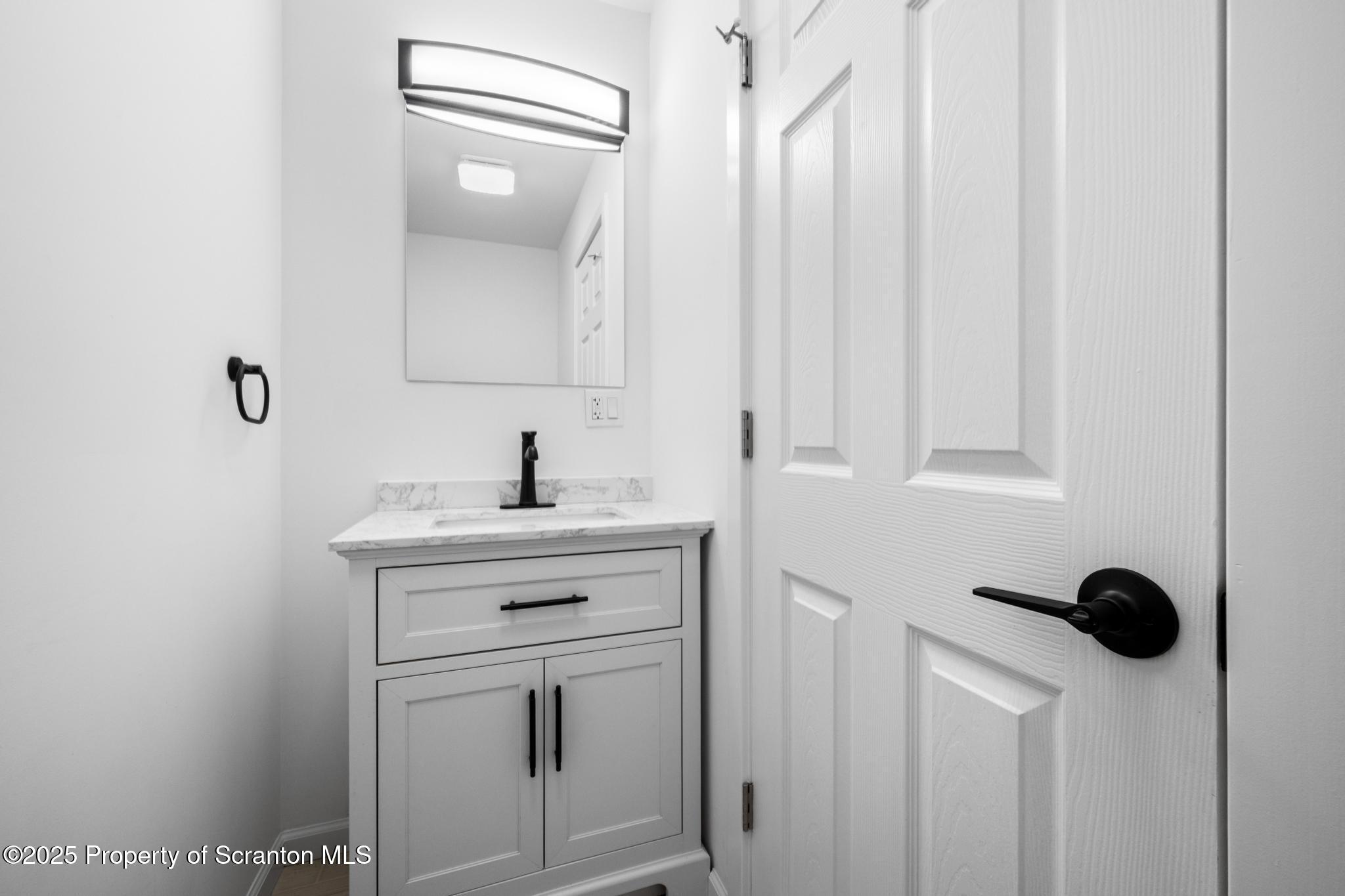 80 Elmhurst Boulevard Scranton, PA 18505 - Photo 26 of 56 a bathroom with a sink a vanity and a mirror