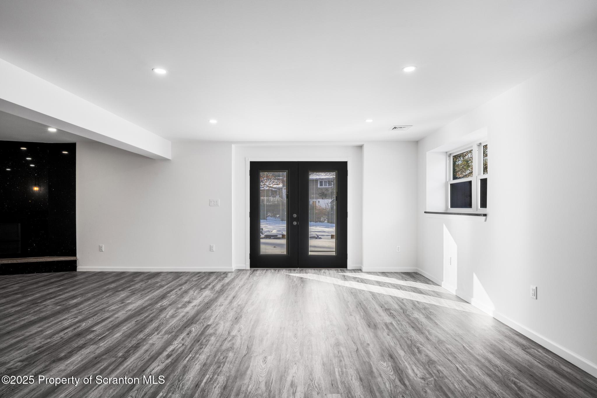 80 Elmhurst Boulevard Scranton, PA 18505 - Photo 31 of 56 a view of an empty room with wooden floor and a window