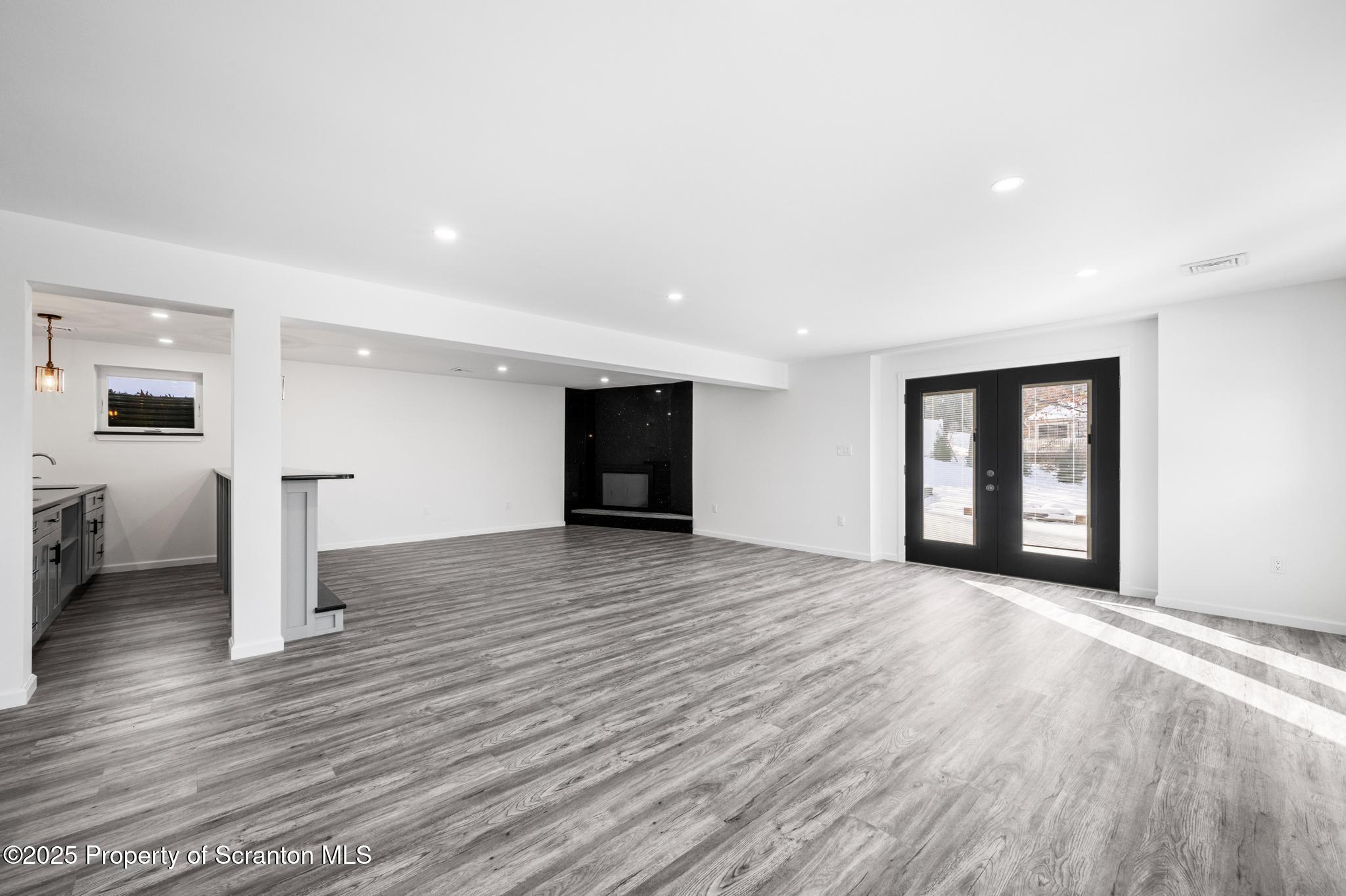 80 Elmhurst Boulevard Scranton, PA 18505 - Photo 32 of 56 a view of an empty room with wooden floor and a window