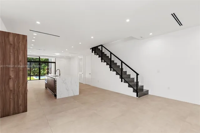 a kitchen with stainless steel appliances a sink stove and cabinets
