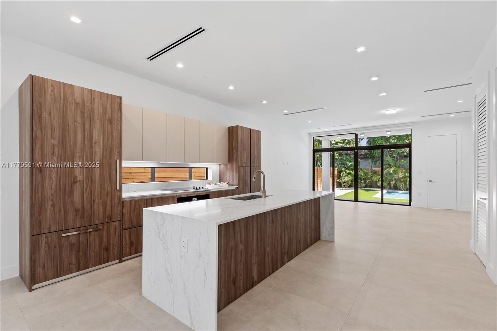 3045 Elizabeth Street, Unit 3045 Miami, FL 33133 - Photo 13 of 72 a kitchen with stainless steel appliances a sink stove and refrigerator