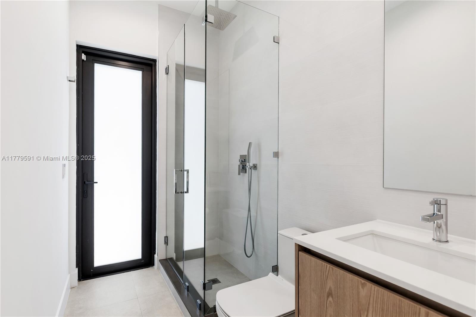 3045 Elizabeth Street, Unit 3045 Miami, FL 33133 - Photo 29 of 72 a bathroom with a sink toilet and shower