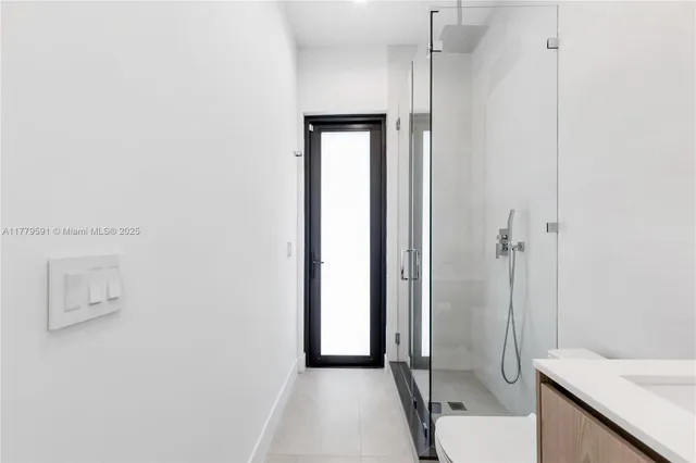 a bathroom with a double vanity sink toilet and a mirror
