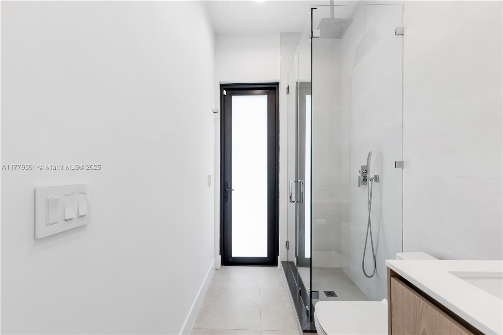 3045 Elizabeth Street, Unit 3045 Miami, FL 33133 - Photo 30 of 72 a view of a bathroom with a shower and a sink