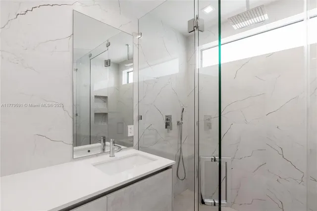 a bathroom with double sink and a mirror