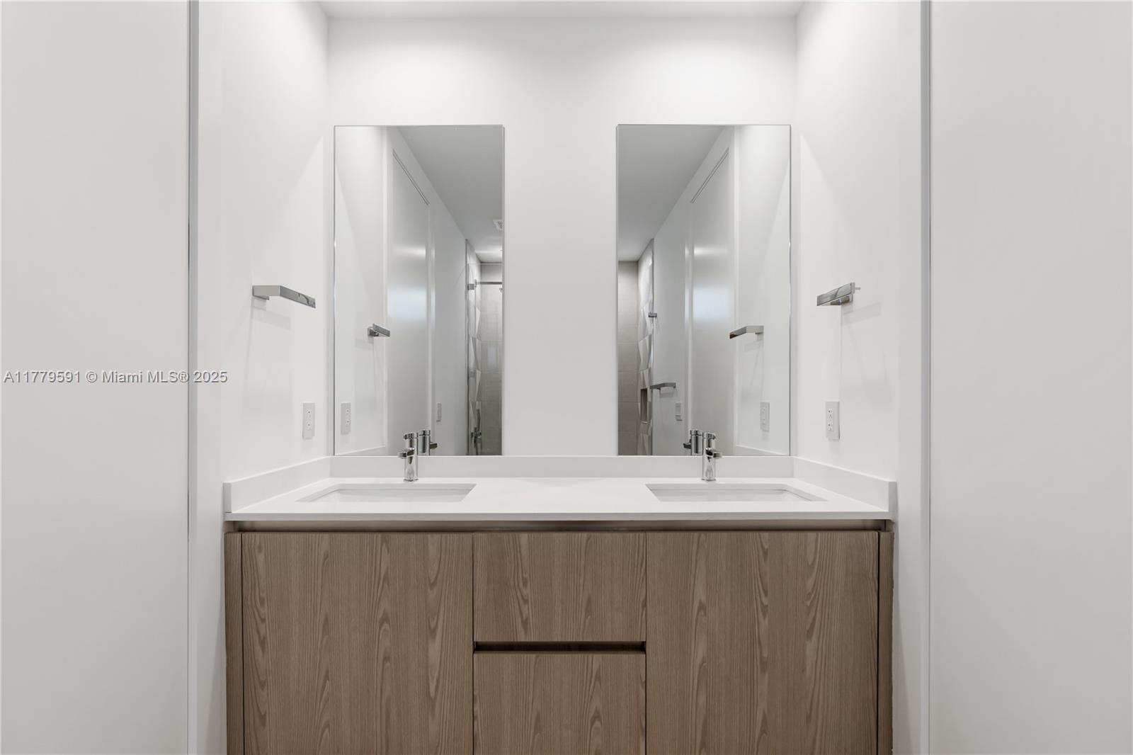 3045 Elizabeth Street, Unit 3045 Miami, FL 33133 - Photo 51 of 72 a bathroom with double sink and a mirror