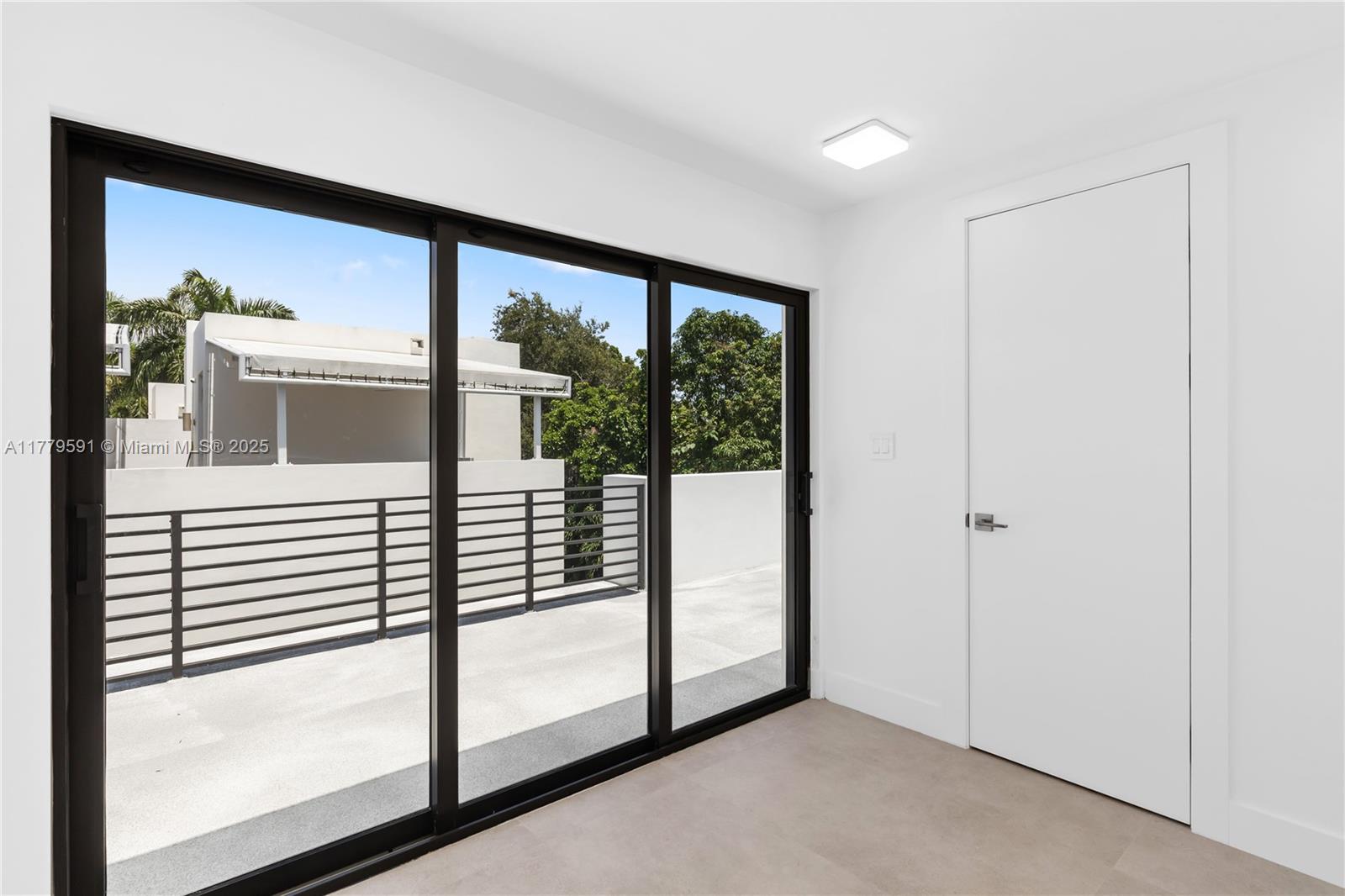 3045 Elizabeth Street, Unit 3045 Miami, FL 33133 - Photo 52 of 72 a view of a porch with a floor to ceiling window