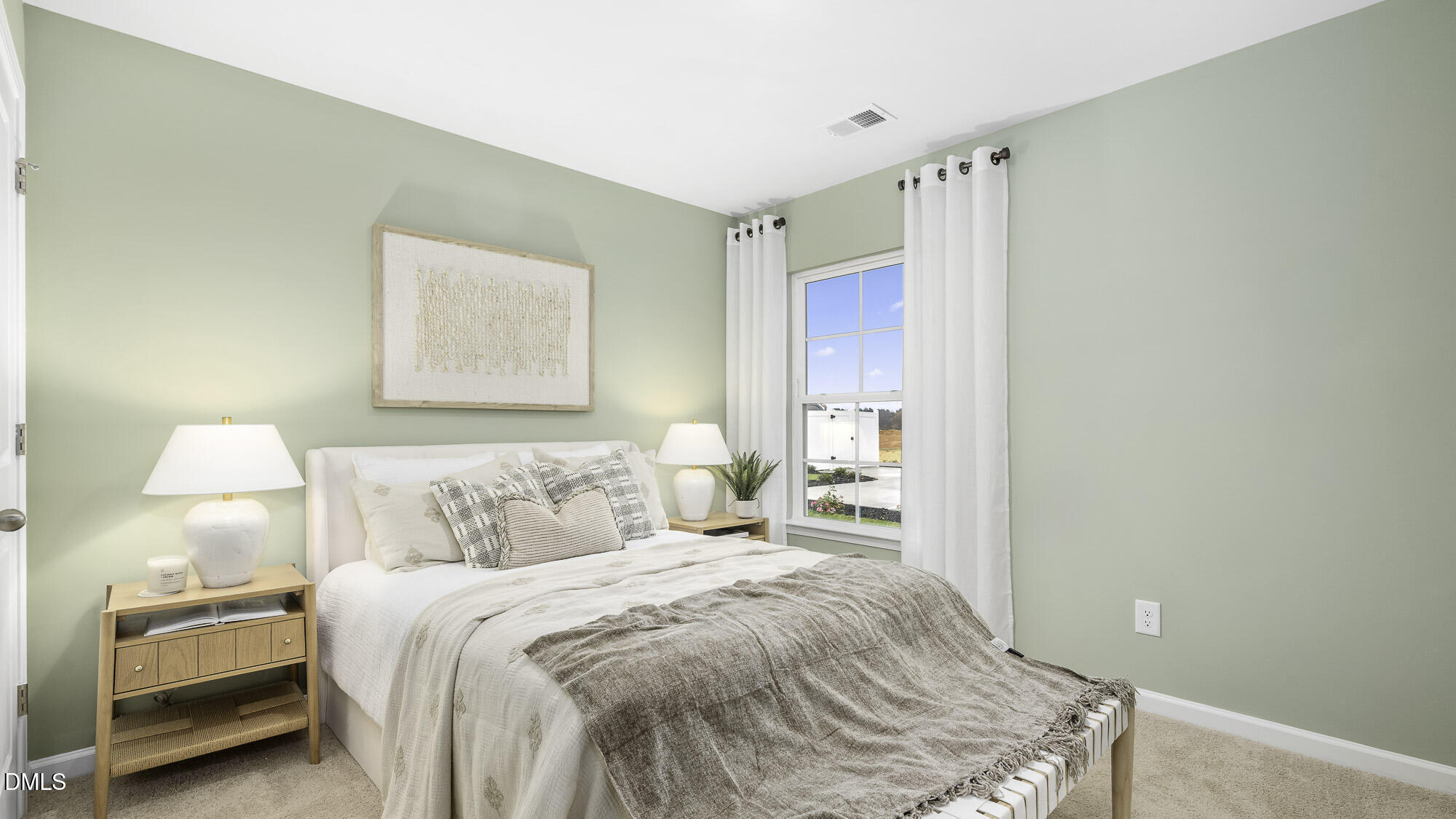 129 Daniel Road Wilson's Mills, NC 27577 - Photo 13 of 28 a bedroom with a bed and a lamp