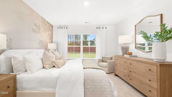 a spacious bedroom with a large bed and a potted plant