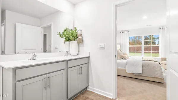 a en suite bathroom with 2 sink and a mirror