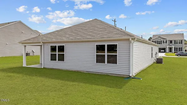 a view of a house with a backyard