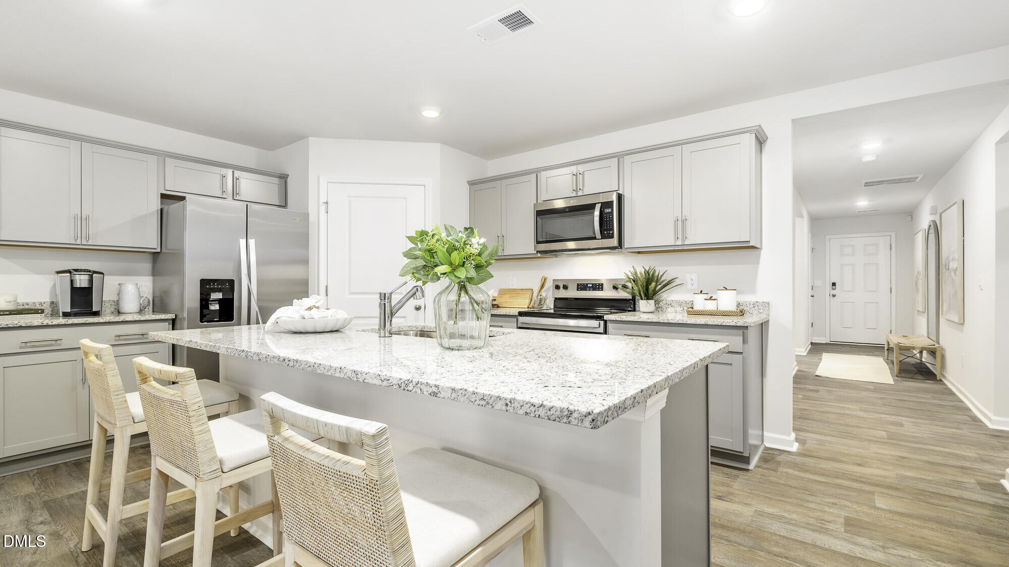 129 Daniel Road Wilson's Mills, NC 27577 - Photo 7 of 28 a kitchen with stainless steel appliances granite countertop a kitchen island stools a stove a sink and a refrigerator