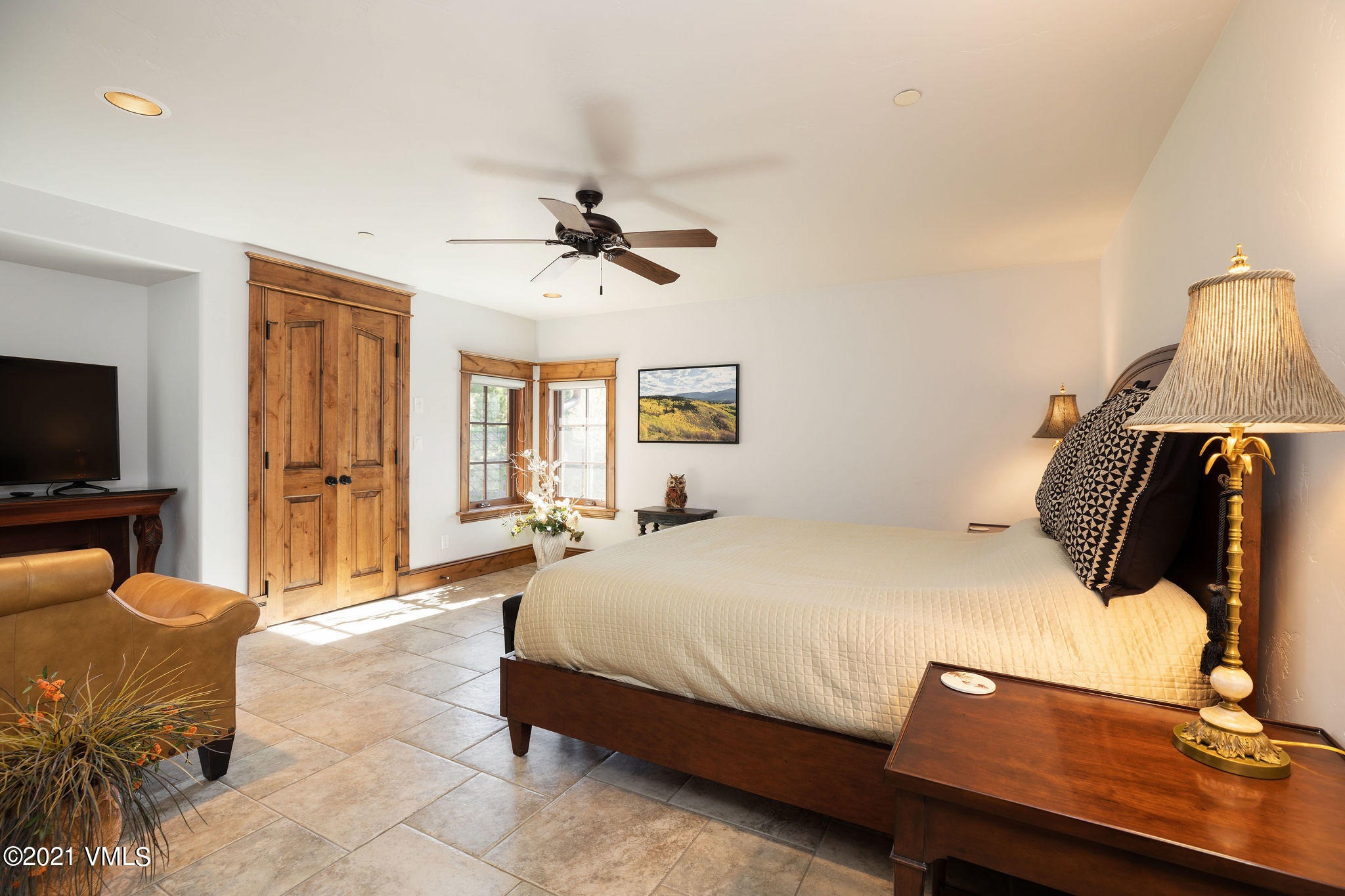 950 Cordillera Way Edwards, CO 81632 - Photo 14 of 26 a bedroom with a bed and wooden floor