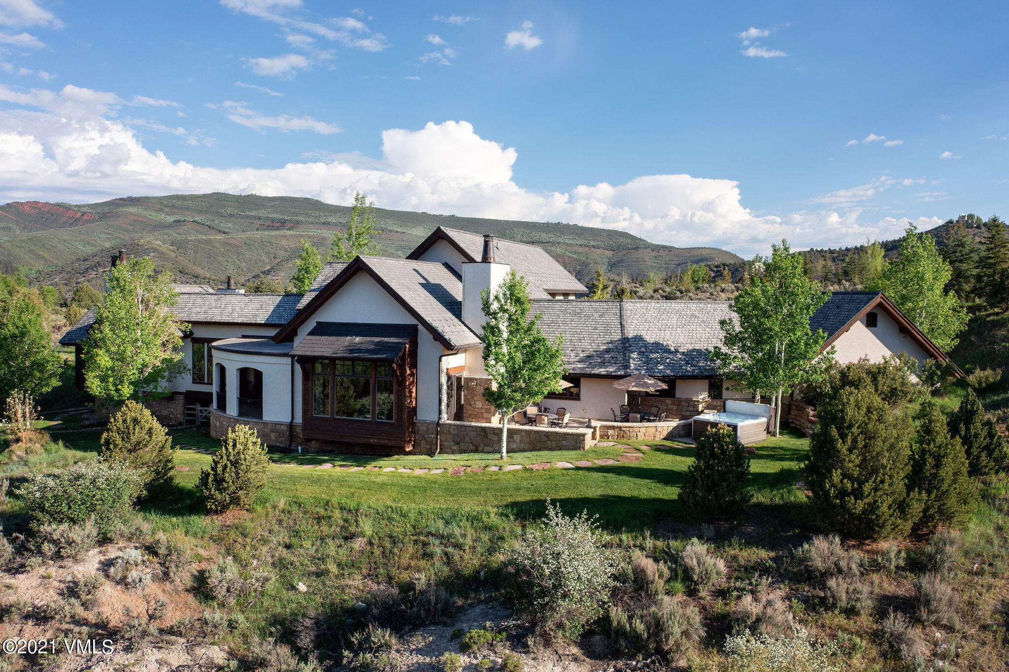950 Cordillera Way Edwards, CO 81632 - Photo 23 of 26 a front view of a house with a yard and mountain view in back