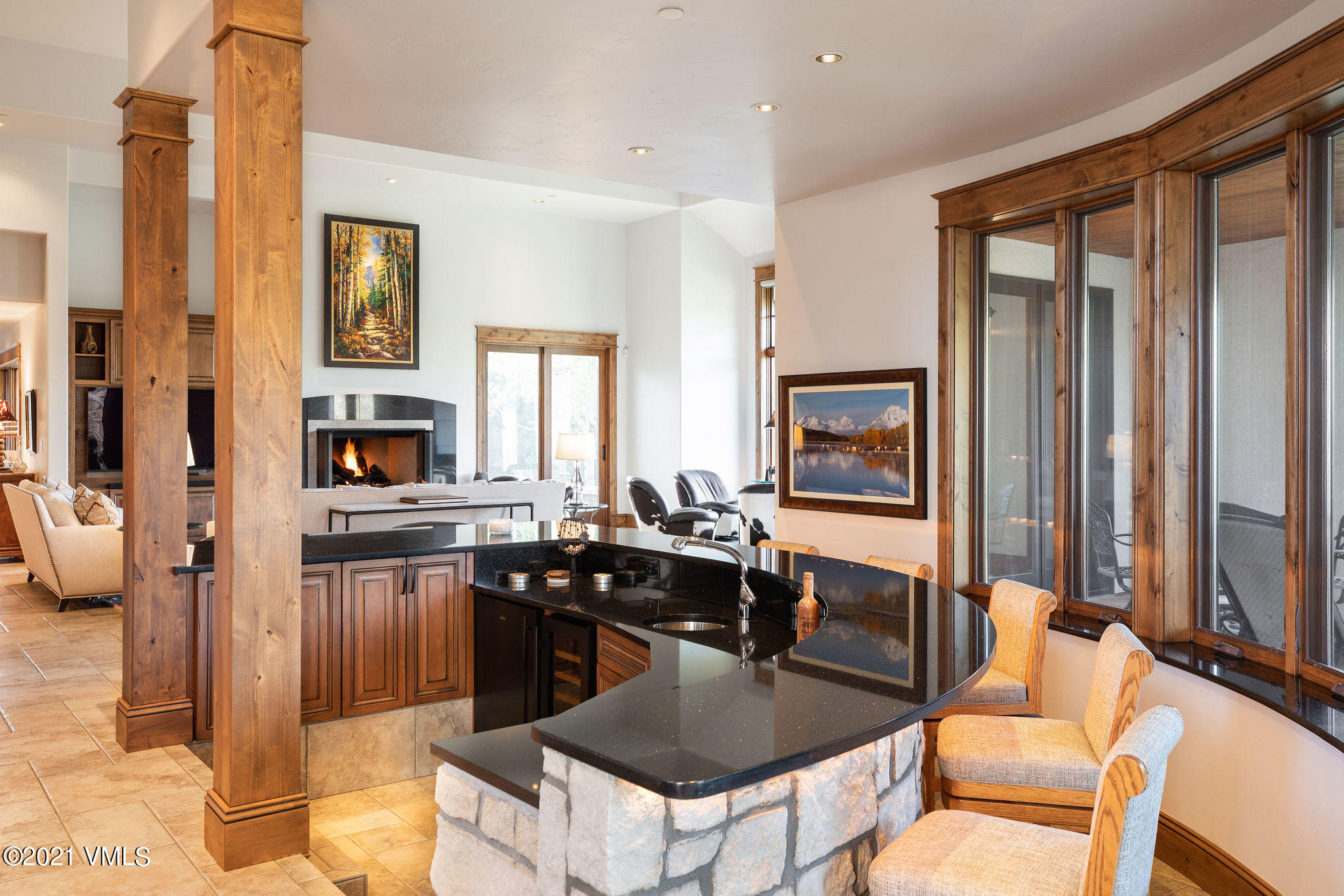 950 Cordillera Way Edwards, CO 81632 - Photo 4 of 26 a kitchen with stainless steel appliances granite countertop a stove top oven a sink a dining table and chairs