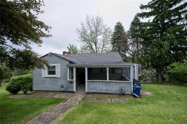 a front view of a house with a garden and deck