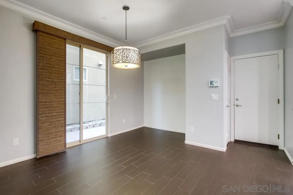 1859 Khaki Lane Chula Vista, CA 91913 - Photo 12 of 62 an empty room with wooden floor chandelier and windows