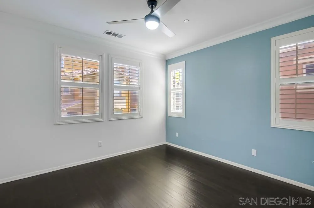 1859 Khaki Lane Chula Vista, CA 91913 - Photo 17 of 62 a view of an empty room with wooden floor and a window