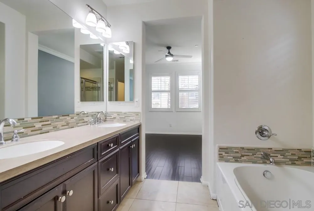 1859 Khaki Lane Chula Vista, CA 91913 - Photo 21 of 62 a bathroom with a sink a vanity and a mirror