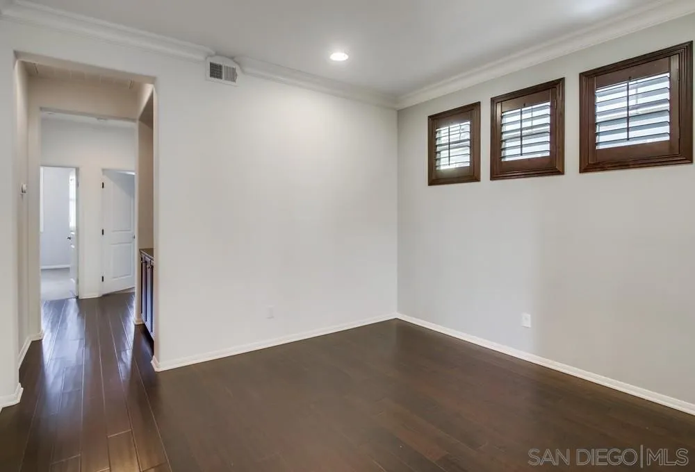 1859 Khaki Lane Chula Vista, CA 91913 - Photo 25 of 62 a view of an empty room with wooden floor and a window