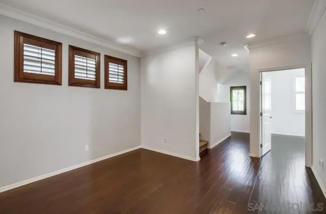 a living room with furniture a ceiling fan and a window