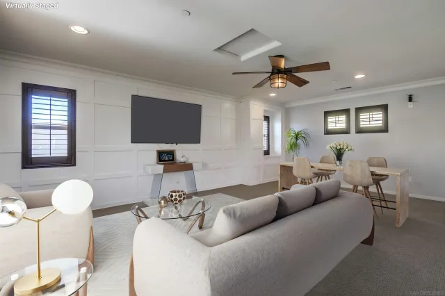 an empty room with windows and fan