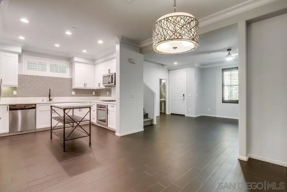 1859 Khaki Lane Chula Vista, CA 91913 - Photo 3 of 62 a kitchen with stainless steel appliances granite countertop a stove top oven a sink dishwasher and a refrigerator with wooden floor