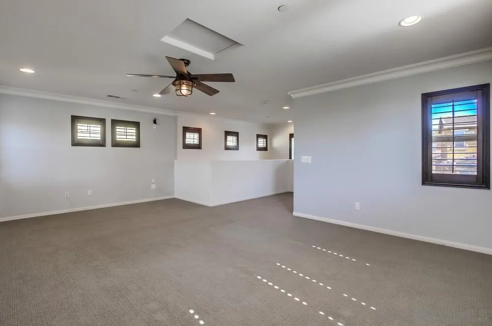 1859 Khaki Lane Chula Vista, CA 91913 - Photo 32 of 62 an empty room with ceiling fan and windows