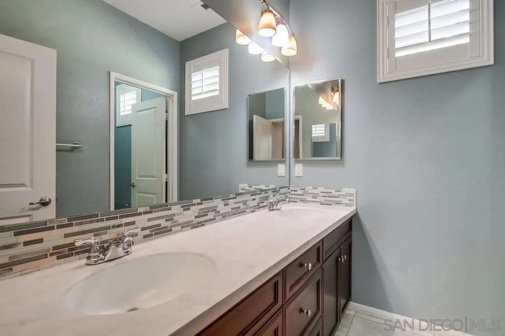1859 Khaki Lane Chula Vista, CA 91913 - Photo 39 of 62 a bathroom with a sink and a mirror