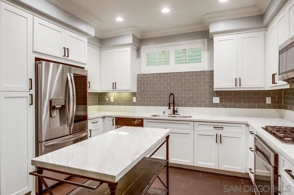 1859 Khaki Lane Chula Vista, CA 91913 - Photo 4 of 62 a kitchen with a stove a sink a refrigerator and cabinets